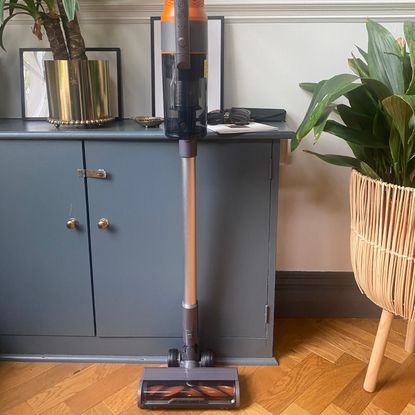 Worx wx038 cordless vacuum cleaner in a hallway with wood parquet flooring