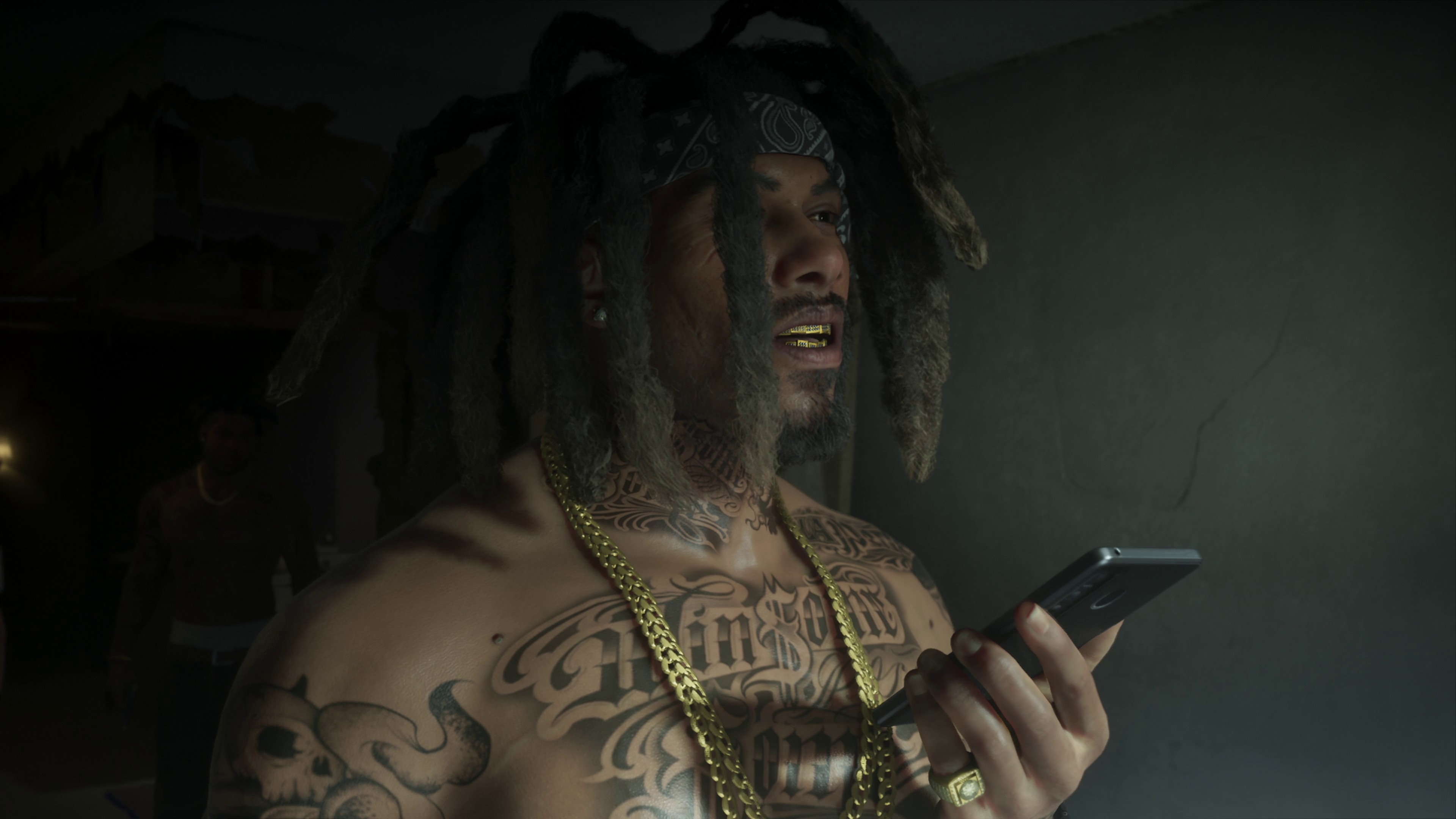 GTA 6 - Raymond, a man with a lot of tattoos, hair in dreads, and wearing gold chains.