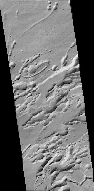 A structure called Arsia Chasmata on the flanks of one of the large Martian volcanoes, Arsia Mons. This view was created by the Colour and Stereo Surface Imaging System (CaSSIS) aboard the European Space Agency's ExoMars Trace Gas Orbiter. The width of the image is around 16 miles (25 kilometers). The formation is volcanic in origin, and pit craters are visible.