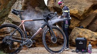 Rider using the Muc-Off Portable Washer cleaning a Canyon bike