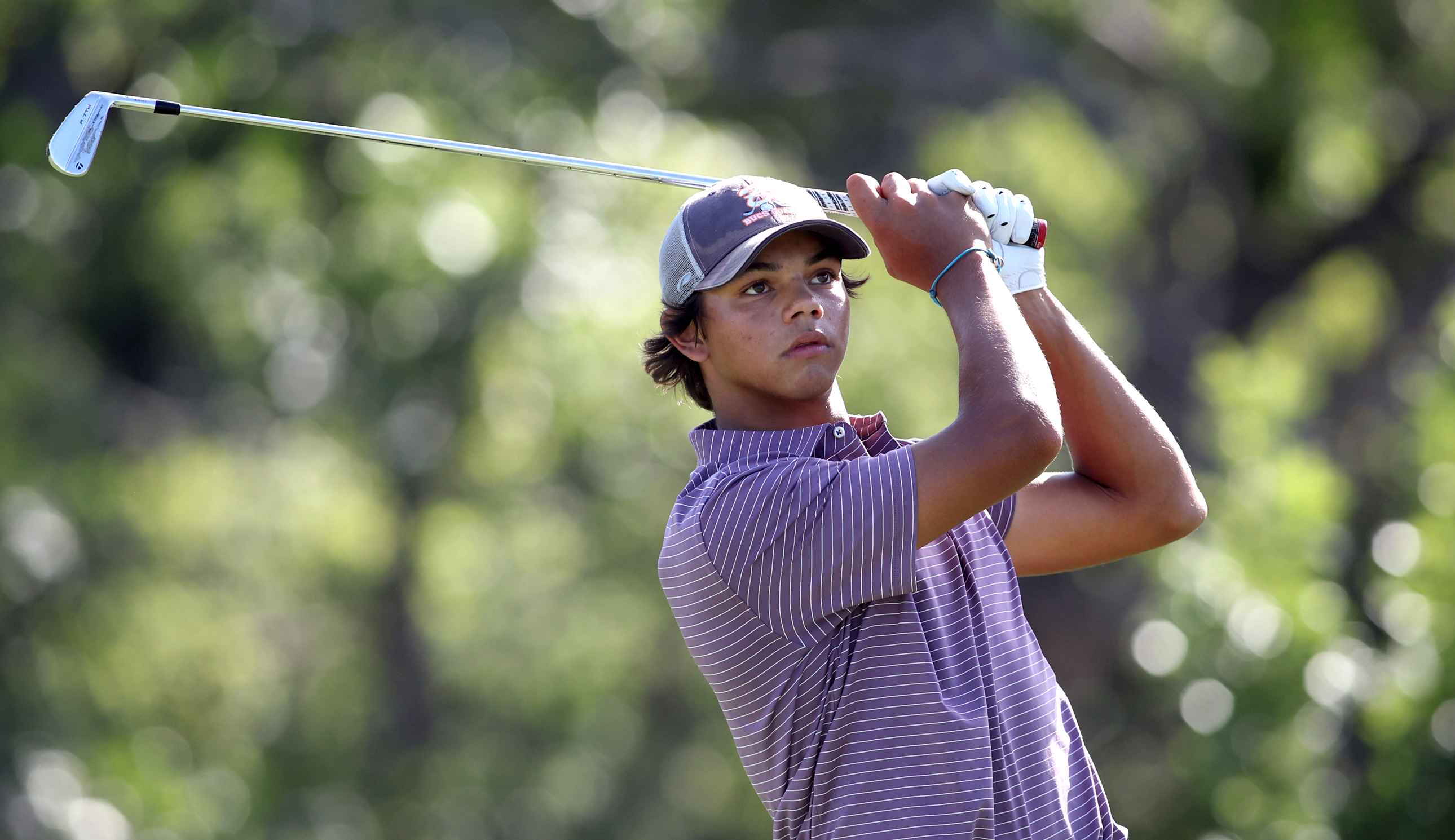 Charlie Woods hits an iron shot