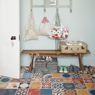 hallway with patchwork flooring and wooden seating table