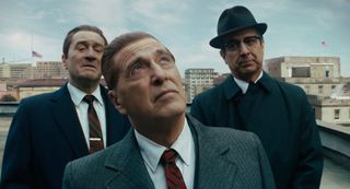 Robert De Niro, Al Pacino and Ray Romano standing on a roof in The Irishman.