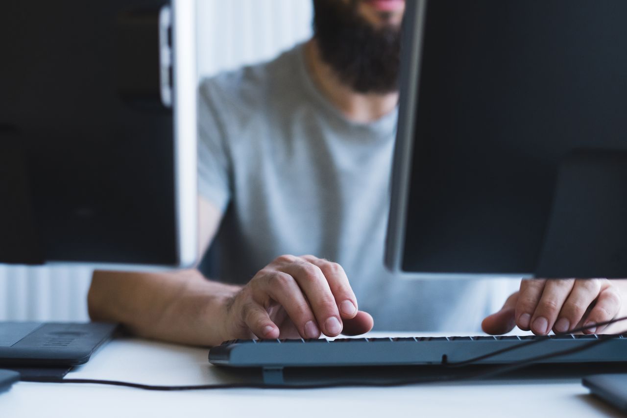 a person working at dual monitors