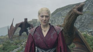 Rhaenyra stands on a hilltop as Syrax and another dragon roar behind her in House of the Dragon season 2, the precursor to House of the Dragon season 3