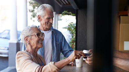 A couple pays for coffee with a credit card.