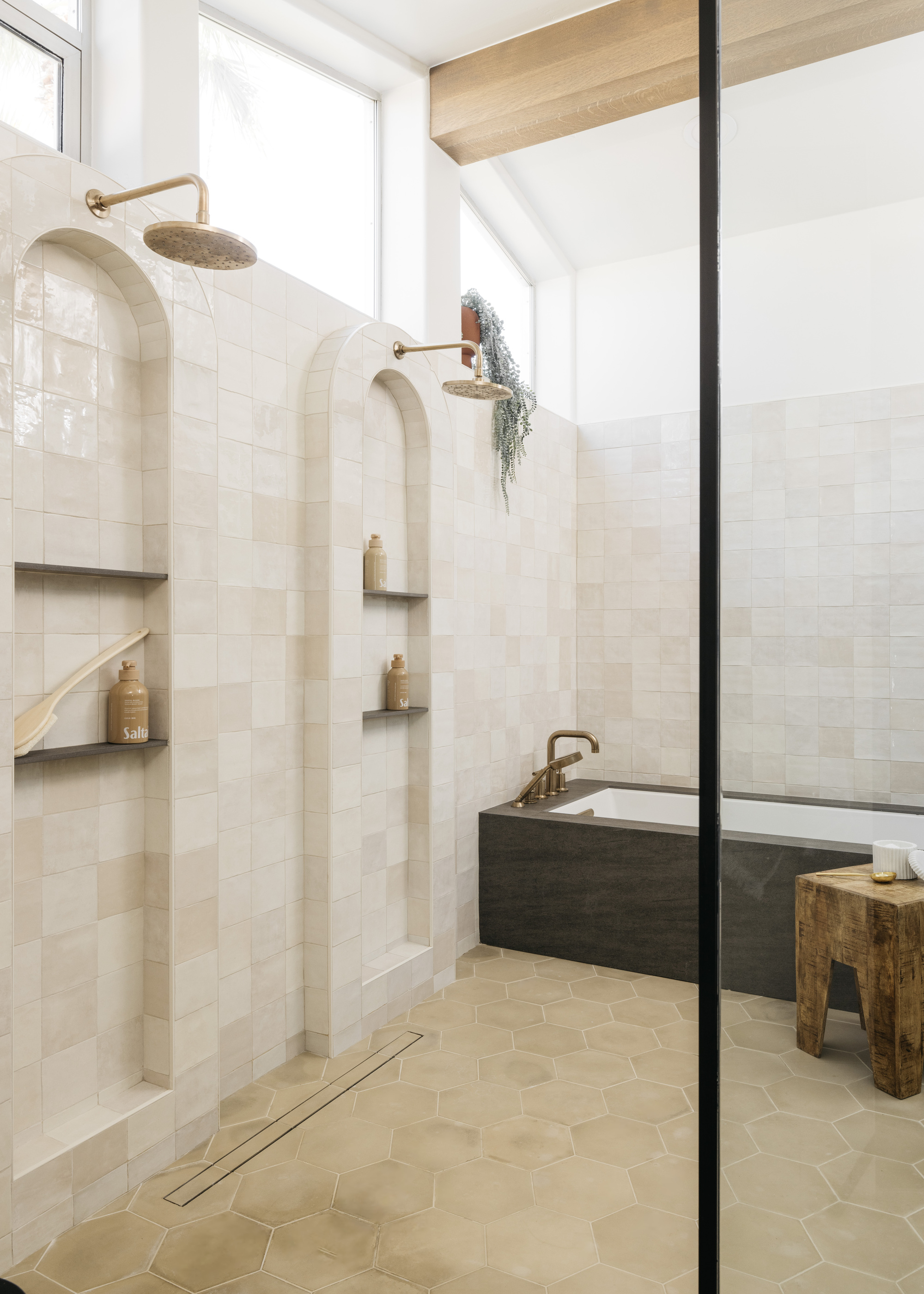 A large wet room with a built-in bath and a double shower