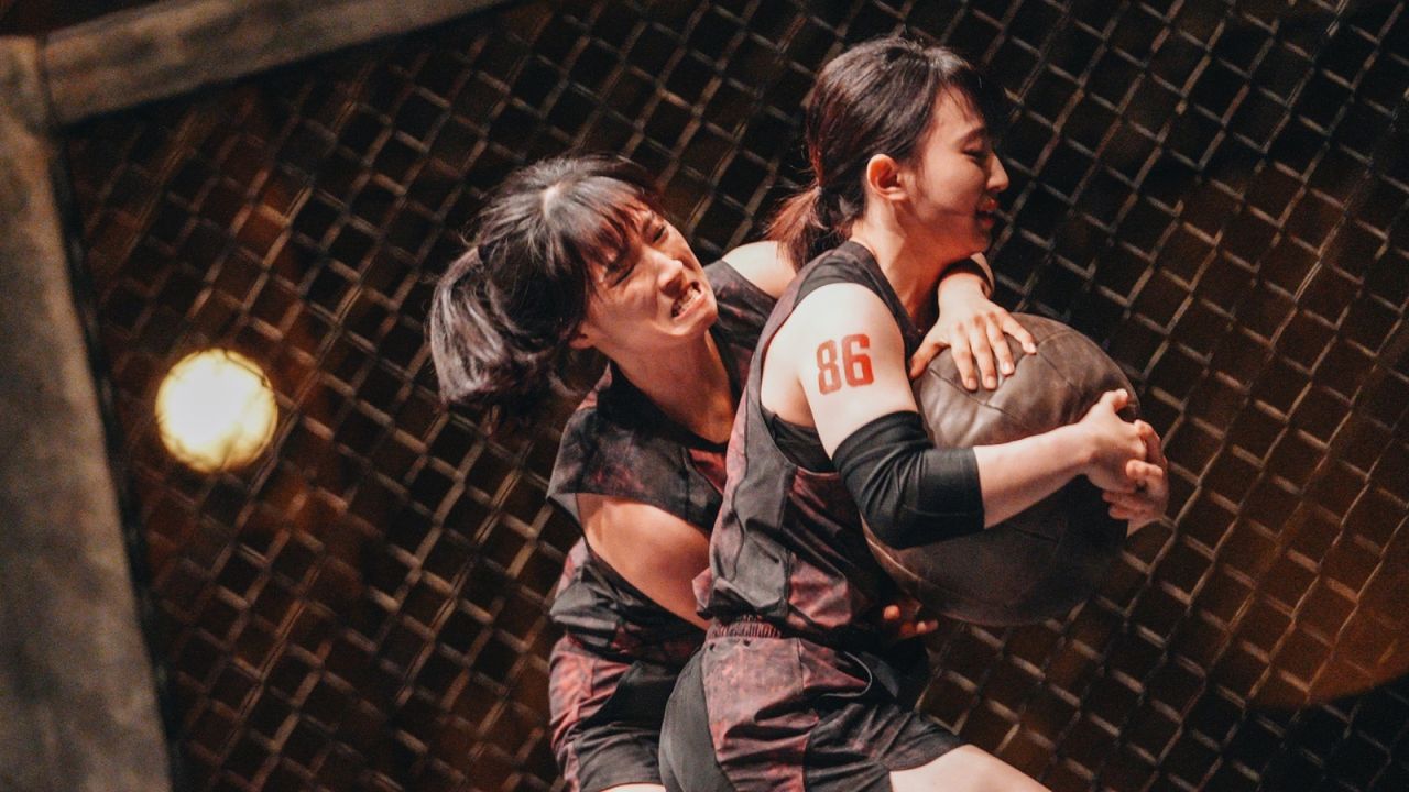 two women (kim hye-bin and kim dam-bi) wrestle over a ball in an octagon, in &#039;physical 100&#039; season 2