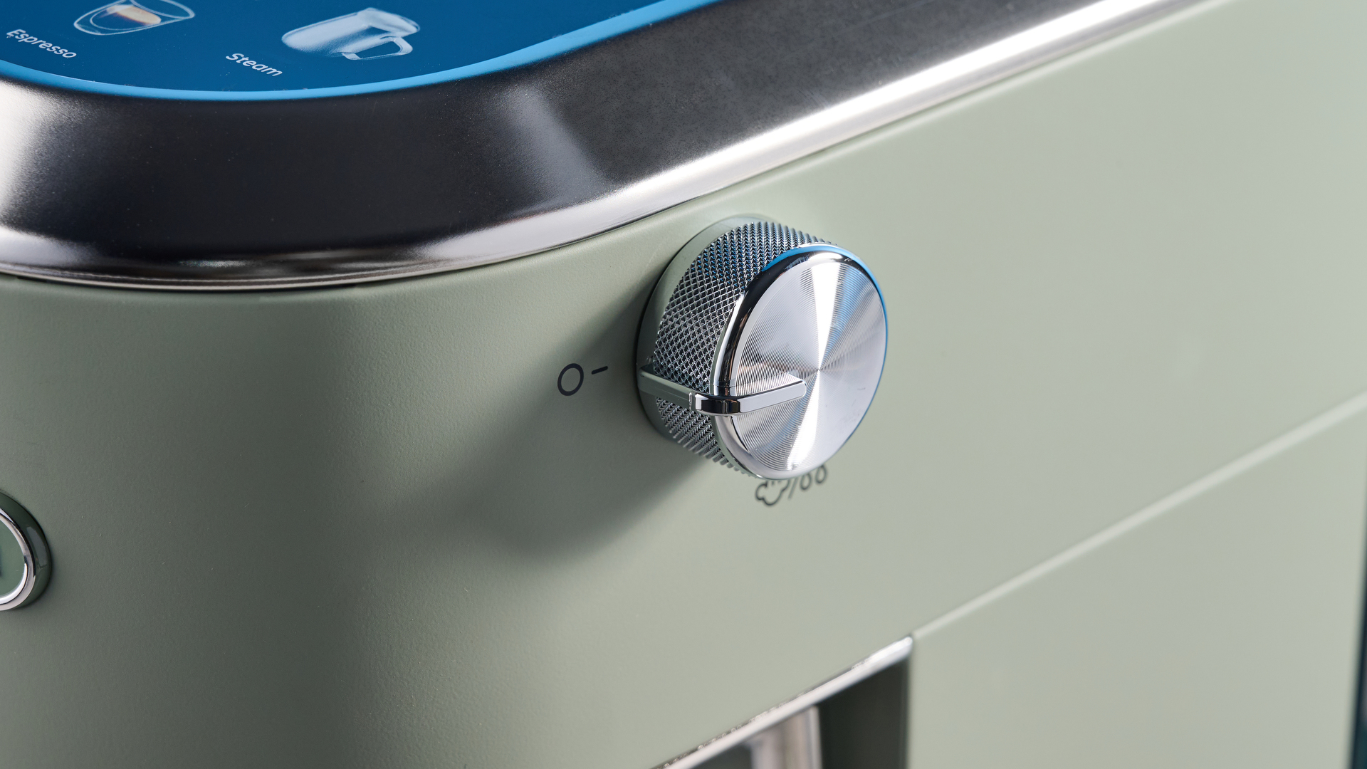 DeLonghi Dedica Duo in the green colorway with accessories photographed on a blue background.