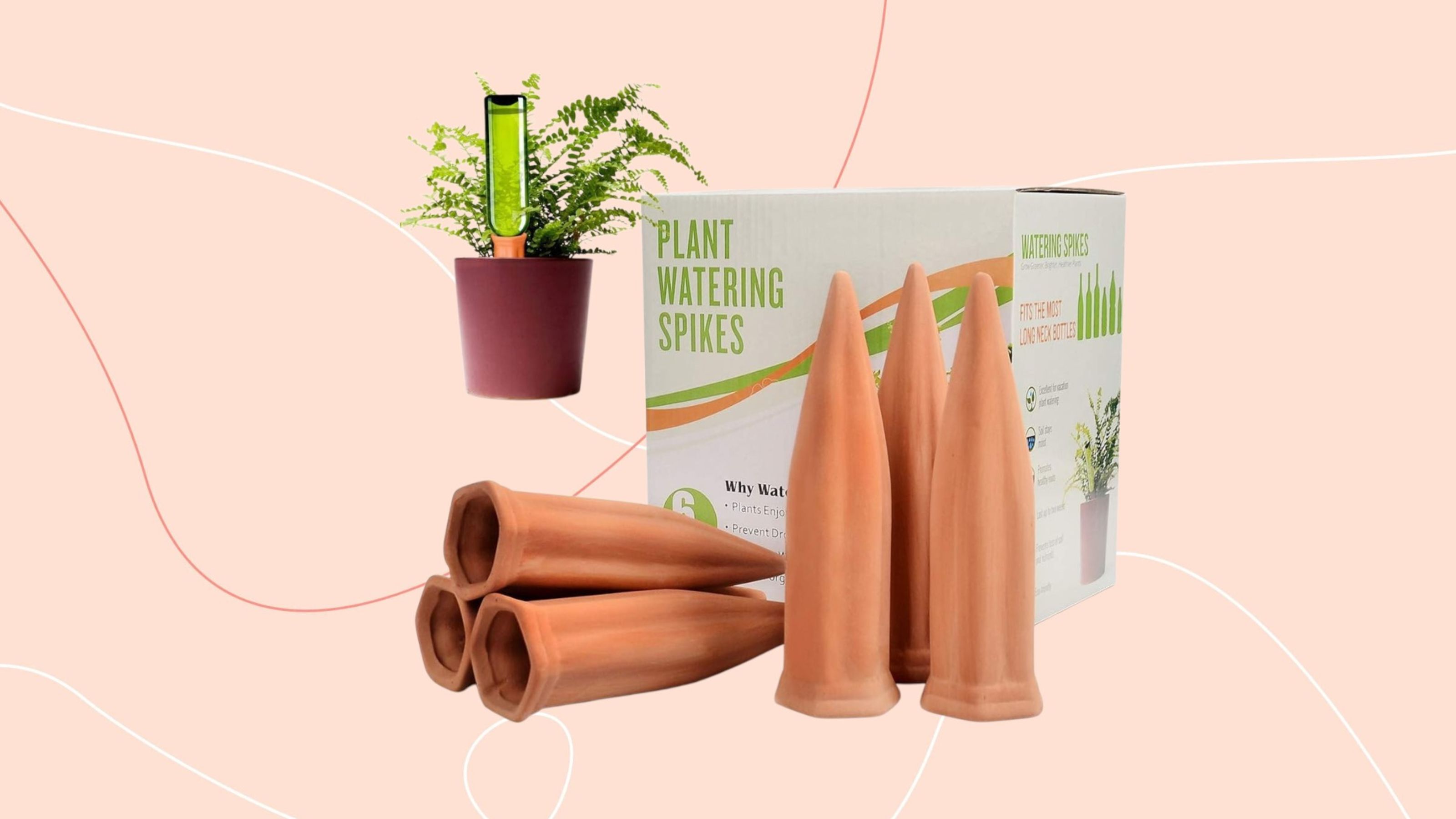 terracotta watering spikes on pink background