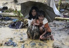Rohingya refugees shelter from the rain
