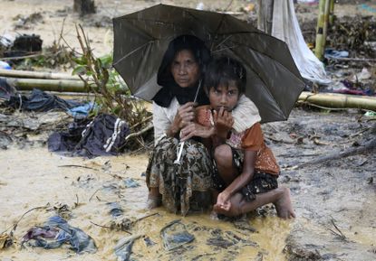 Rohingya refugees shelter from the rain