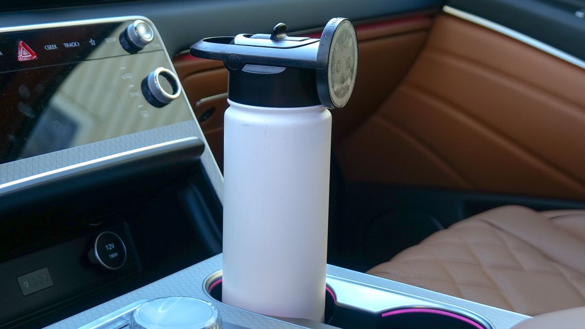 Scosche MagicMount Flask used in car cup holder with iPhone connected to it via MagSafe.