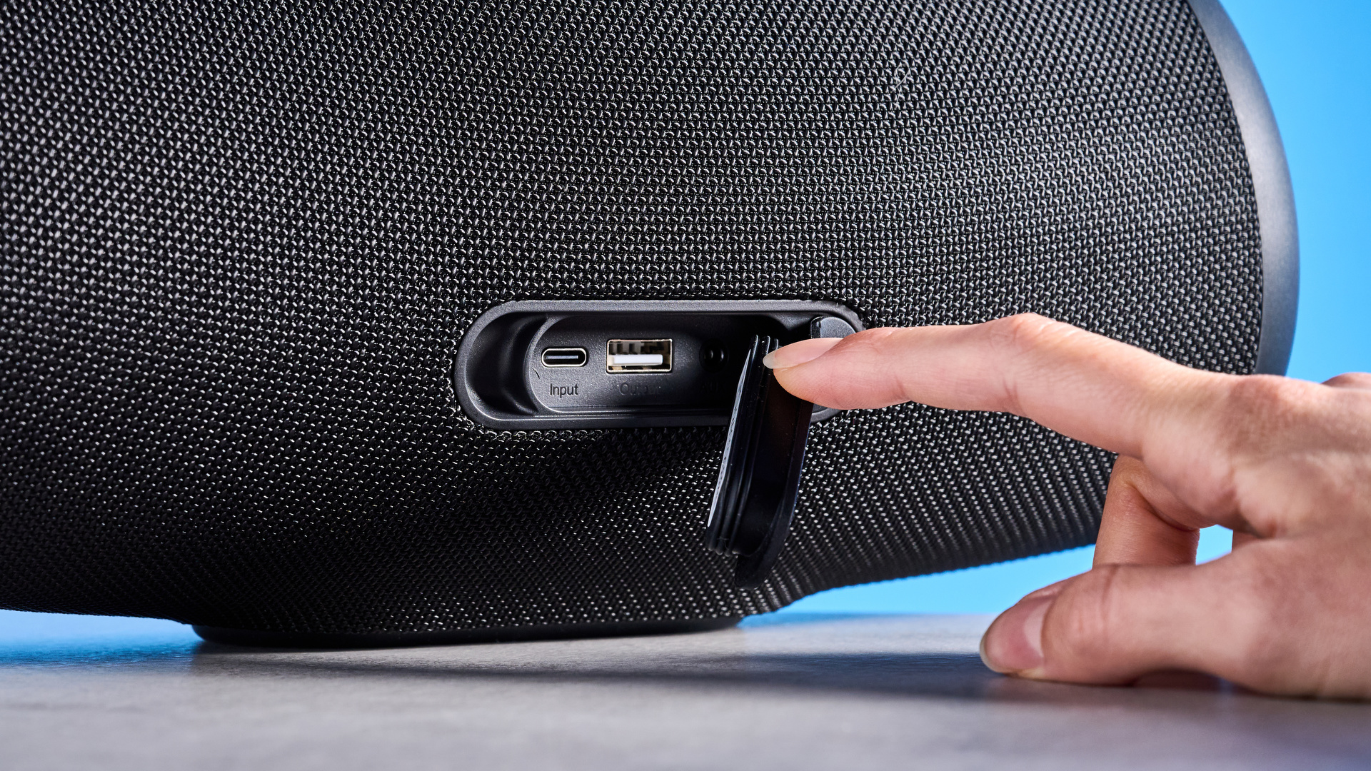 Tribit StormBox Lava Bluetooth Speaker photographed in front of a blue background.