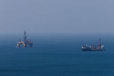 Oil stocks: a offshore oil platform and a support vessel at sea