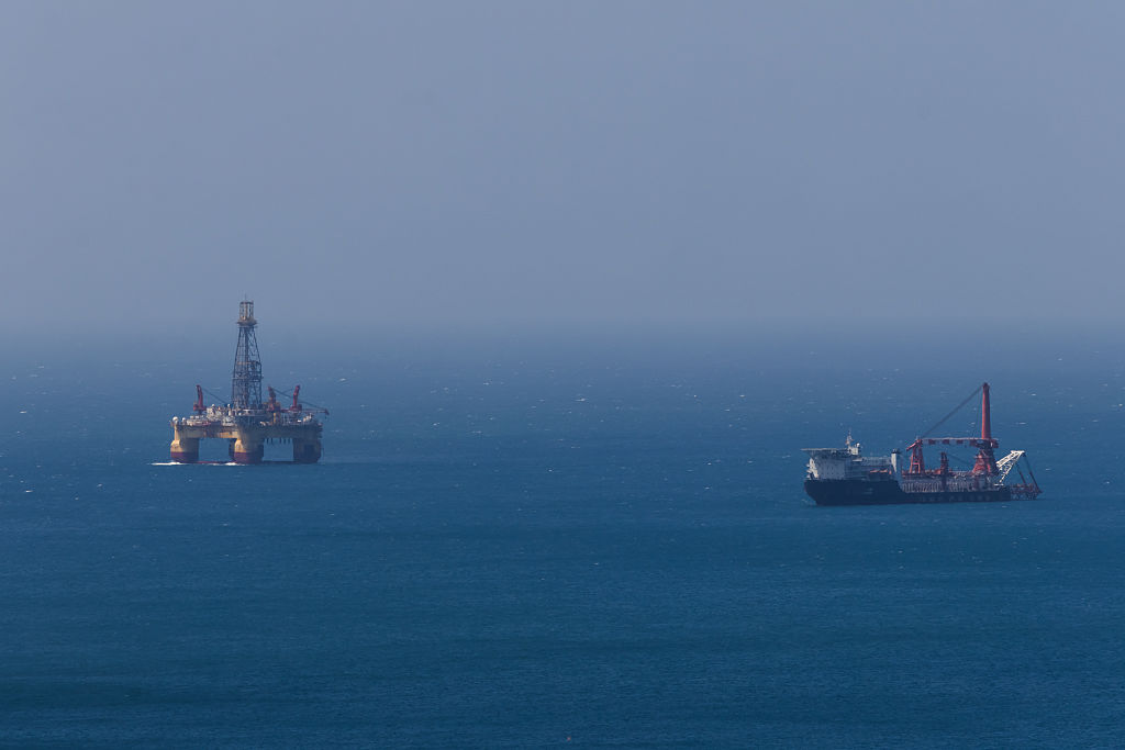 Oil stocks: a offshore oil platform and a support vessel at sea
