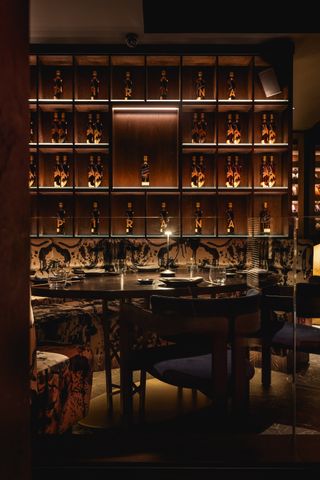 Piraña restaurant interior with shelving filled with bottles in the background