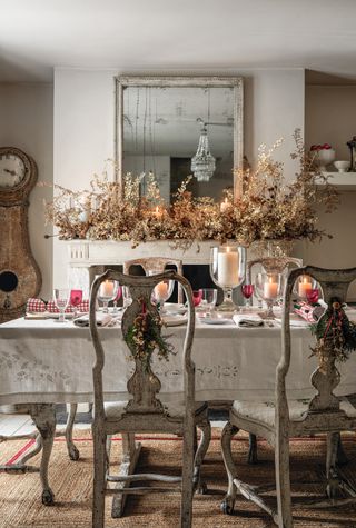 Dining room decorated for Christmas with a dried flower mantel garland