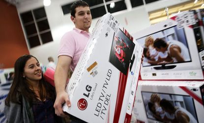Black Friday shoppers giddily prepare their purchases at a Best Buy in Florida.