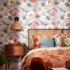 bedroom with floral wallpaper and wooden bed