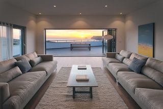 living room with grey sofa and big window