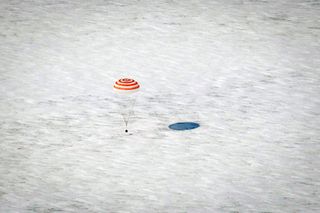 The Soyuz TMA-01M spacecraft floats down to Earth near the town of Arkalyk, Kazakhstan on Wednesday, March 16, 2011. The vessel carried Expedition 26 Commander Scott Kelly and Flight Engineers Oleg Skripochka and Alexander Kaleri. Russian cosmonauts Skrip