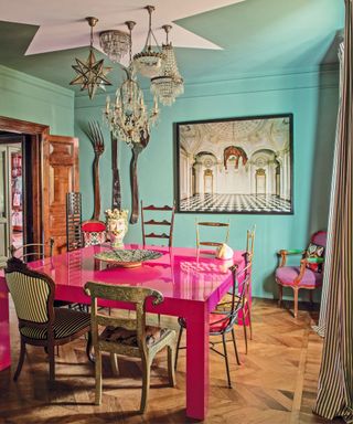 Blue walls, pink table, wooden floor