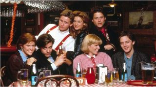 A 1980s image of the 'Brat Pack' cast of "St. Elmo's Fire" gathered around a table in a bar