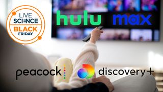 A child operates a remote at a TV from a sofa with various streaming network logos laid on top