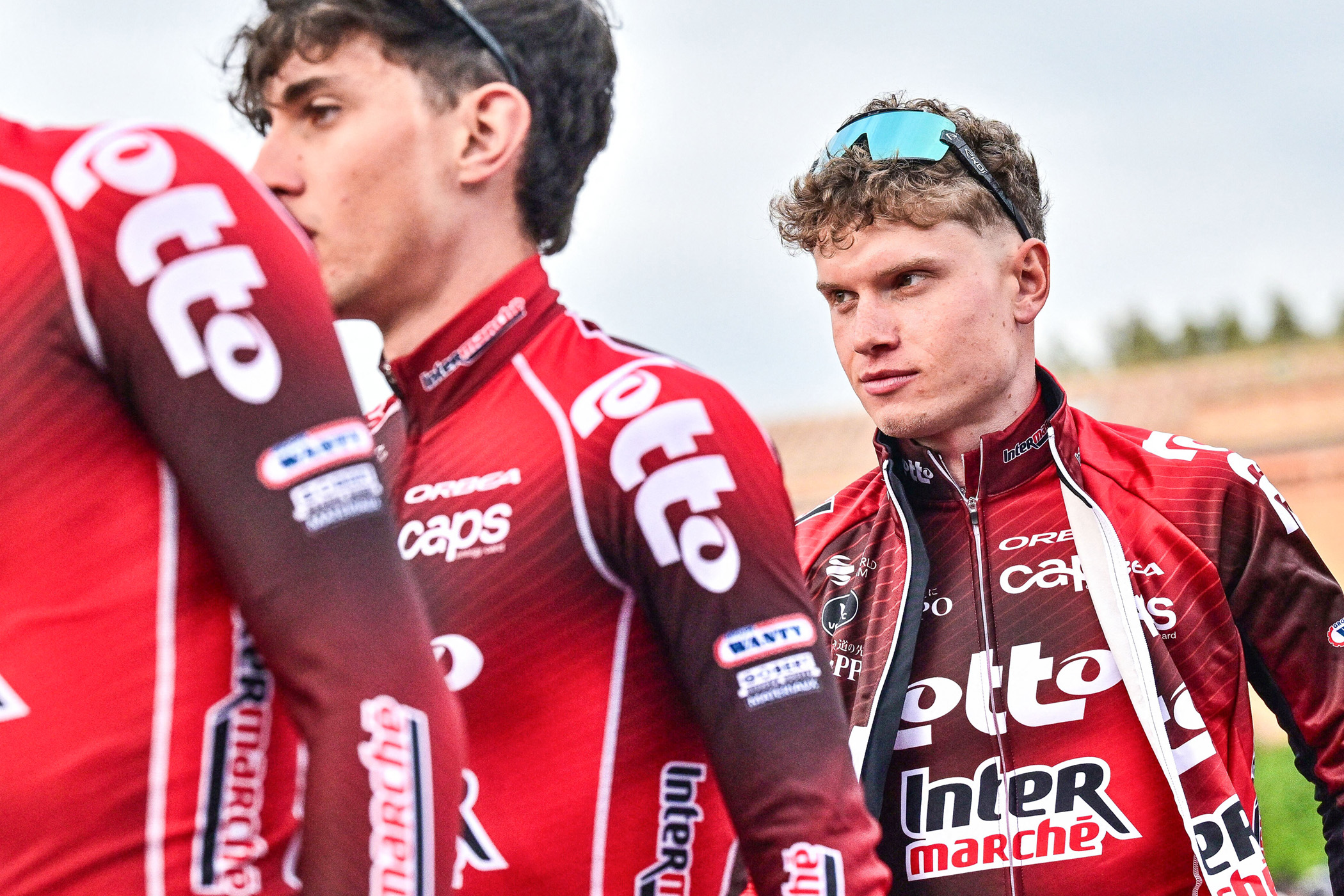 Belgian Lennert Van Eetvelt behind two Lotto Intermarch&eacute; teammates lining up for sign-on