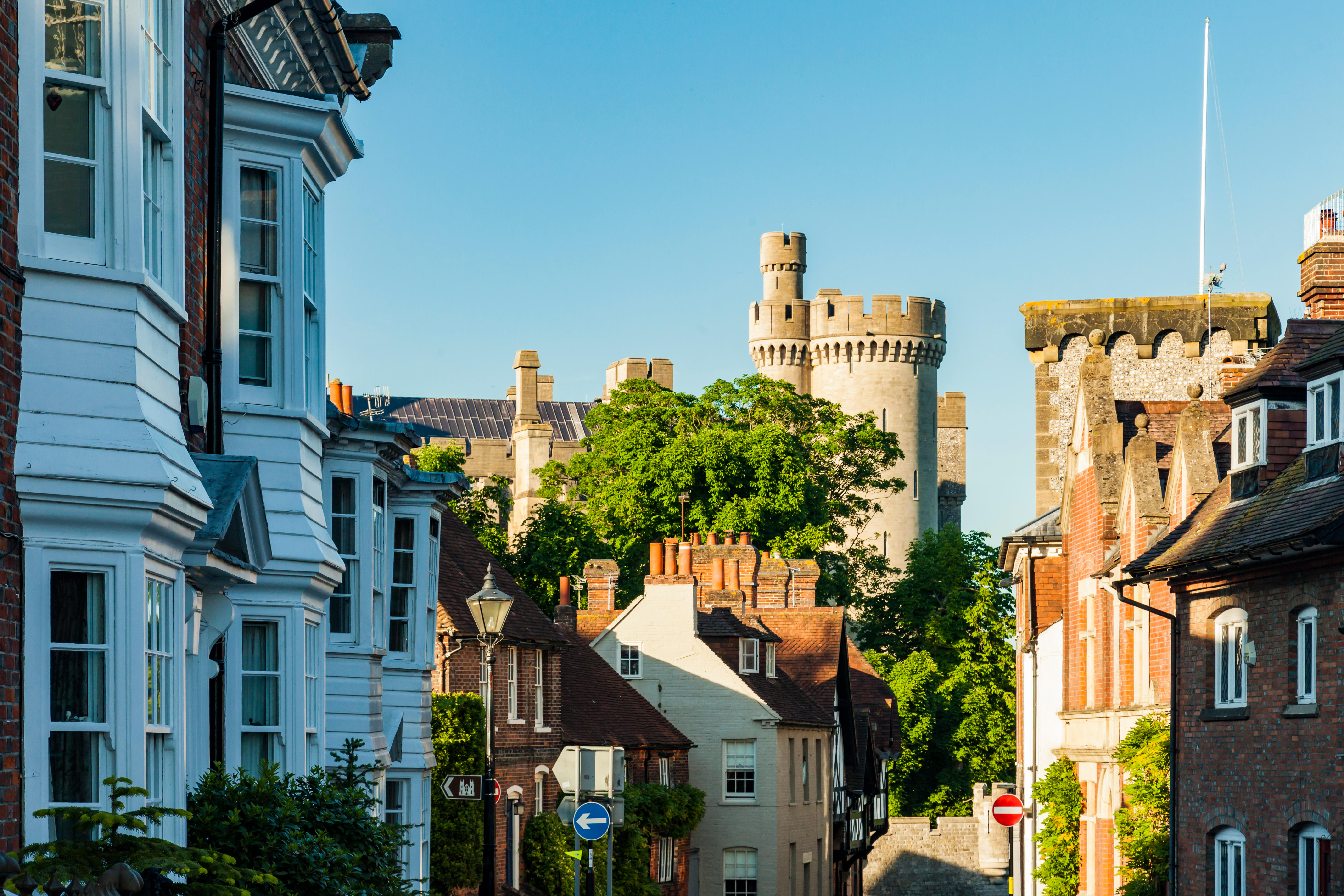 English high street of brick and clapboard houses leading up to a castle