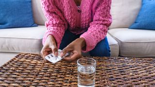 woman taking a probiotic supplement