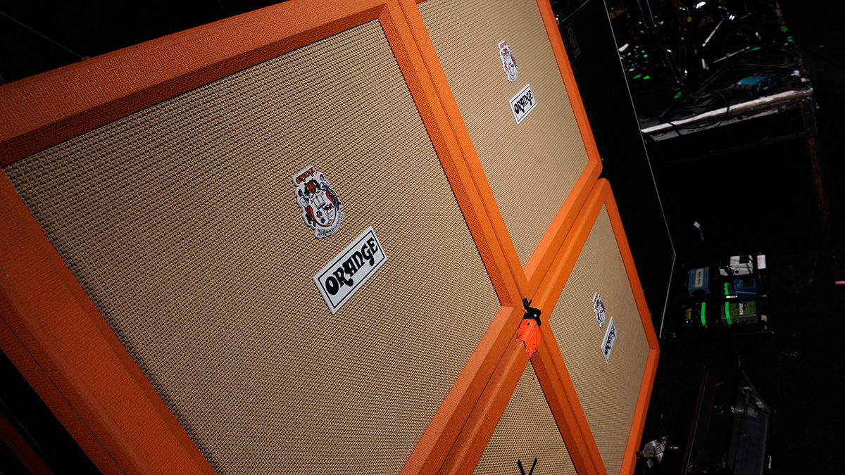 A stack of Orange electric guitar amplifier speaker cabinets owned by the members of English metalcore band Architects