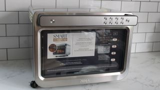 Ninja Prestige Smart XL Air Fryer & Countertop Oven being tested in a white kitchen