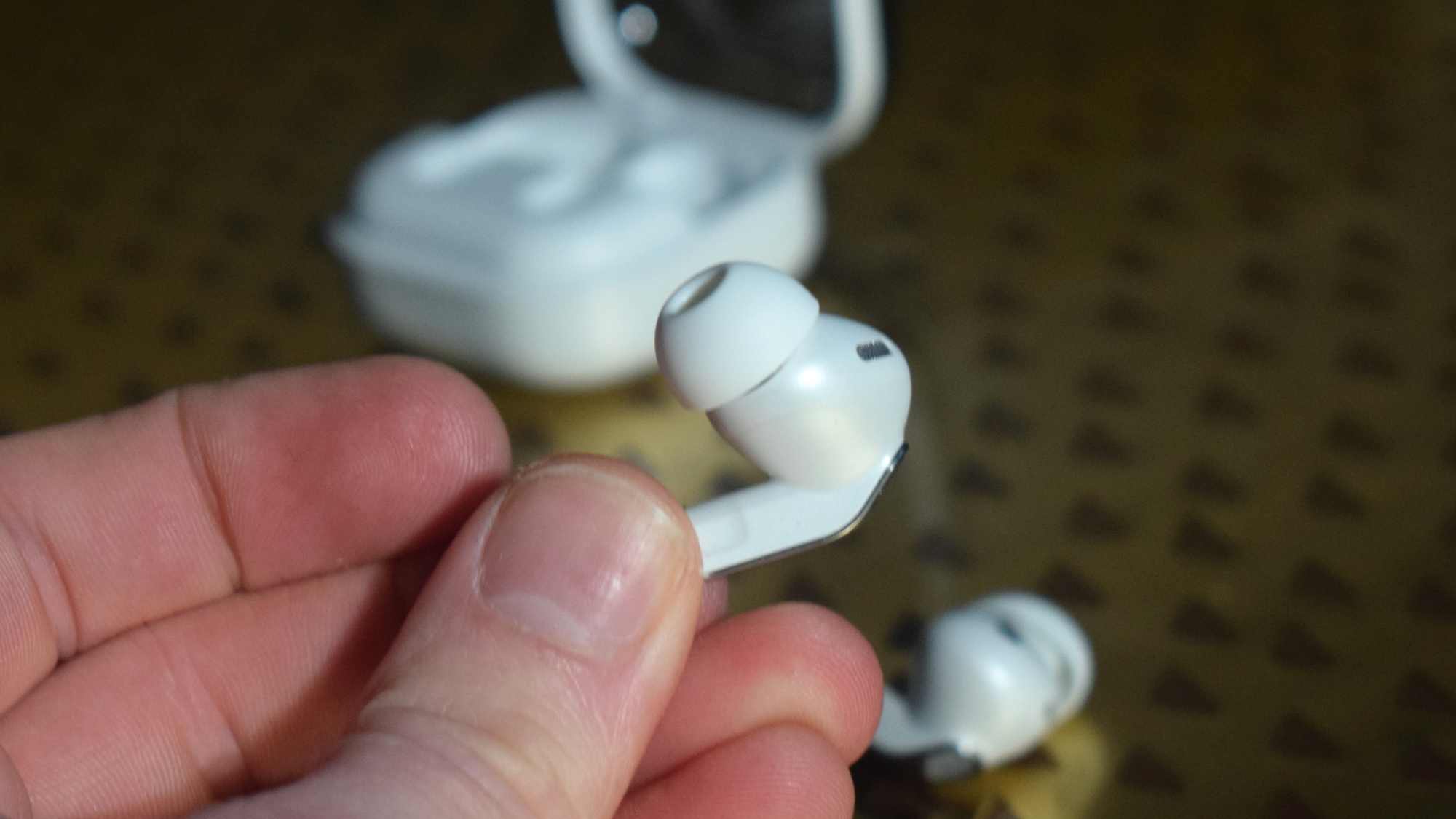 The Samsung Galaxy Buds 4 Pro in a man's hand.
