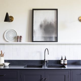 Black and white kitchen with black tap on kitchen sink