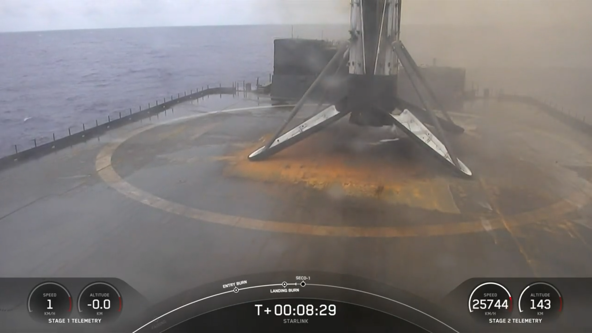 A used rocket stands on sooty landing legs on a drone ship at sea