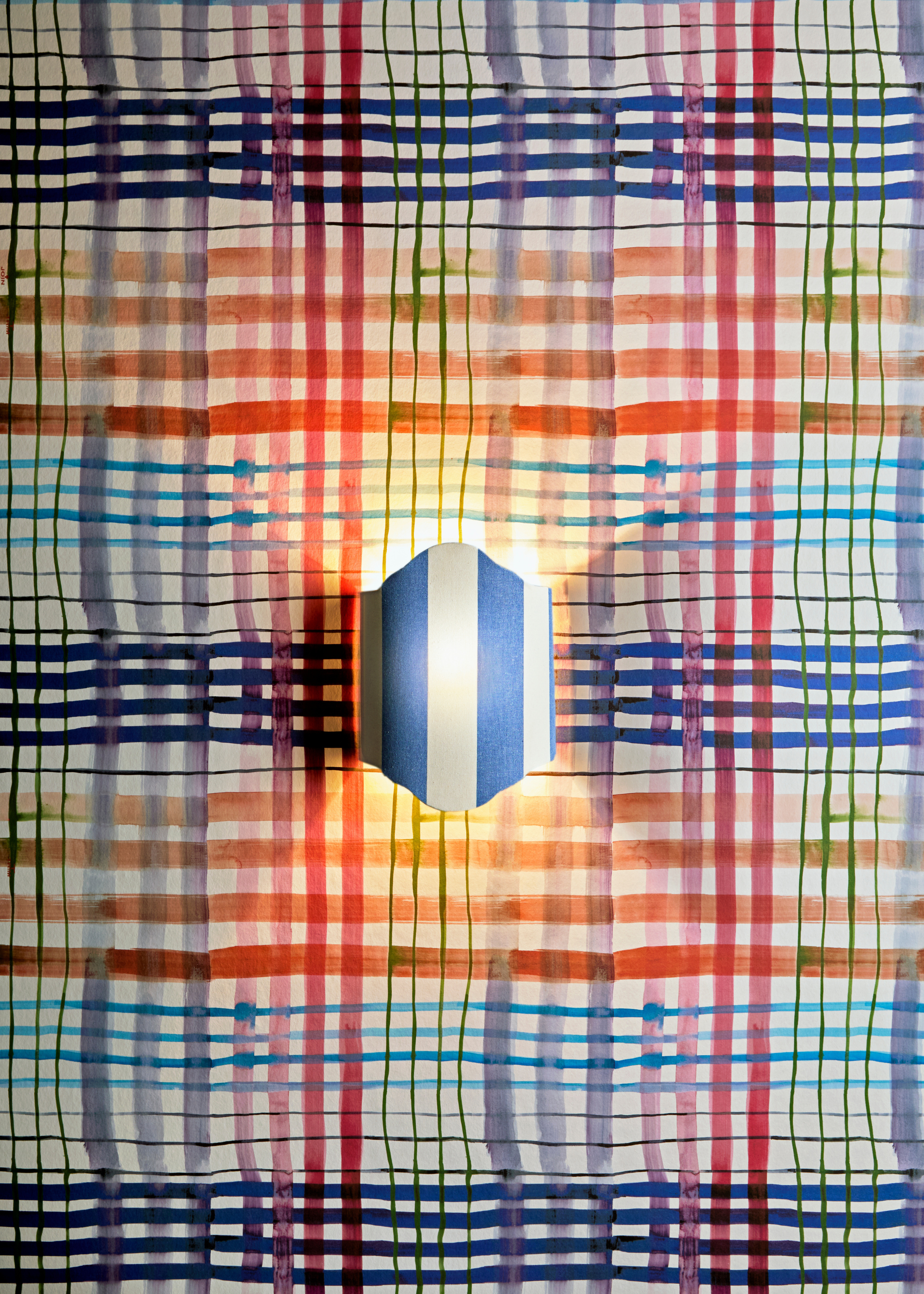 a design showcase featured a wall sconce with blue and white stripes against a vibrantly coloured and patterned wallpaper