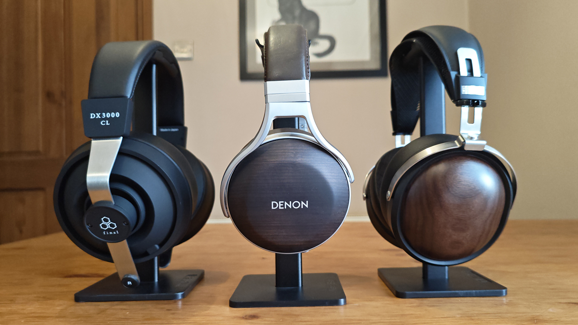 The Denon AH-D5200 and other headphones, photographed on a home desktop. 