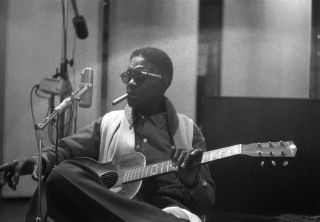 LOS ANGELES - JULY 6: Bluesman Lightnin' Hopkins seen through the window of the studio while recording his album 'Penitentiary Blues' on July, 6, 1960 in Los Angeles, California. (Photo by Michael Ochs Archives/Getty Images)