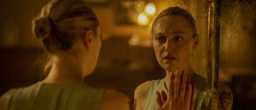 Polly holding hand up to mirrored reflection in Vicious