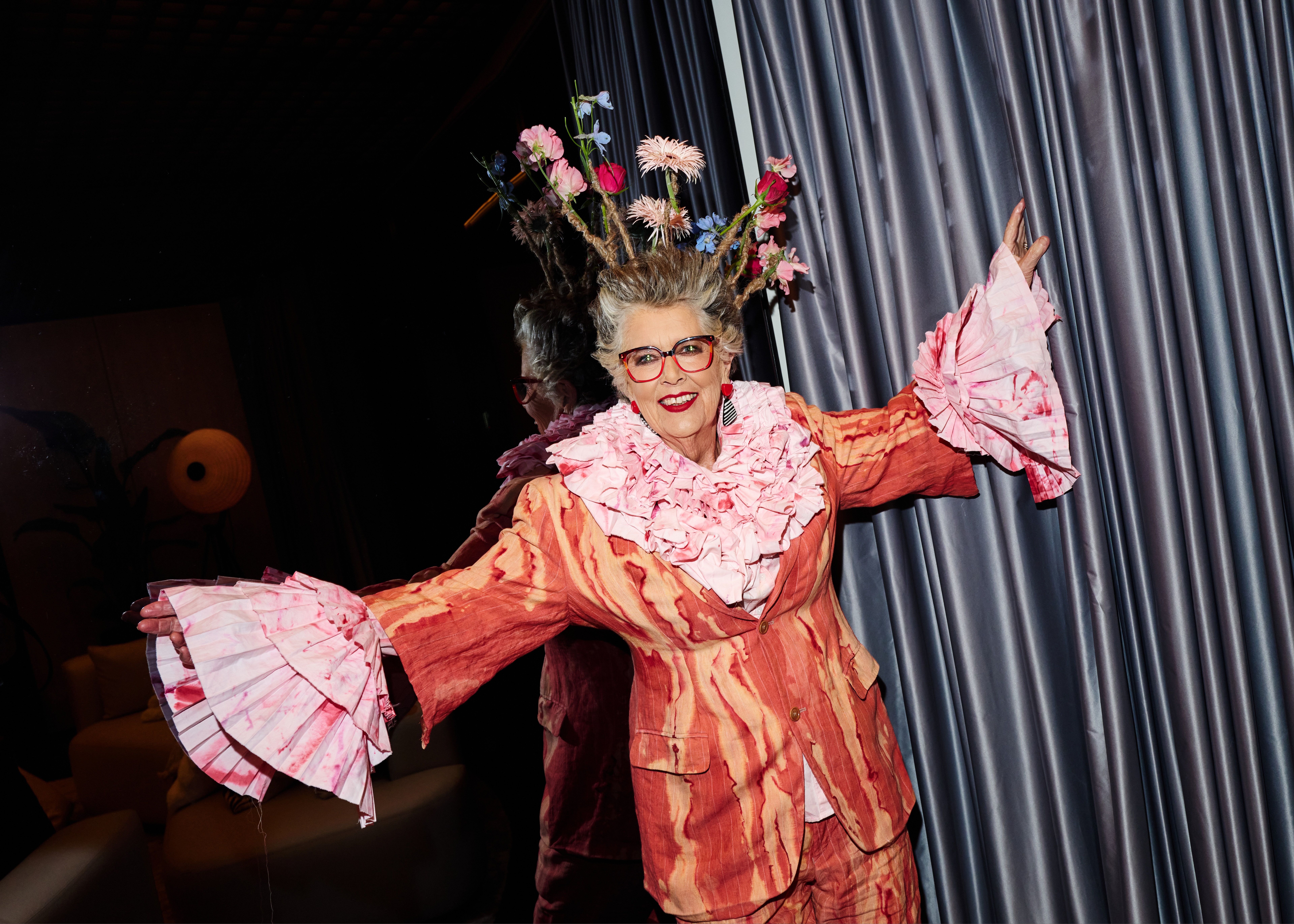Prue Leith in an orange and pink ruffle outfit