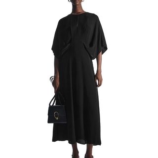 model wearing black Cos Draped Dress