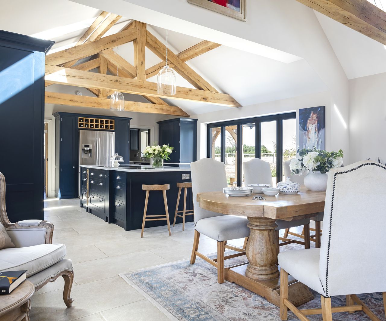 A kitchen-diner in an oak-frame build with bifold doors