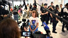 Greta Thunberg talks to reporters in Paris airport