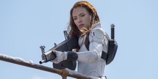 Scarlett Johansson pointing a gun in Black Widow white suit