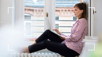 Woman researching causes of hot flashes apart from menopause, sitting on radiator next to open window