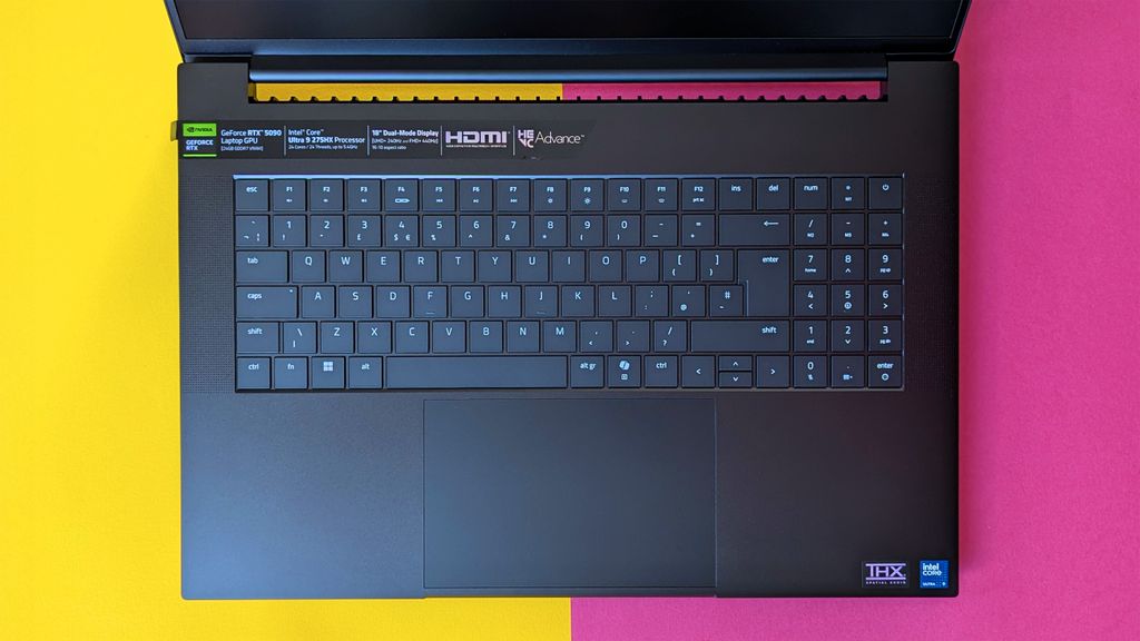 Razer Blade 18 (2025) gaming laptop on a pink and yellow background.