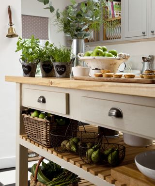 kitchen with table having racks and plant in pots