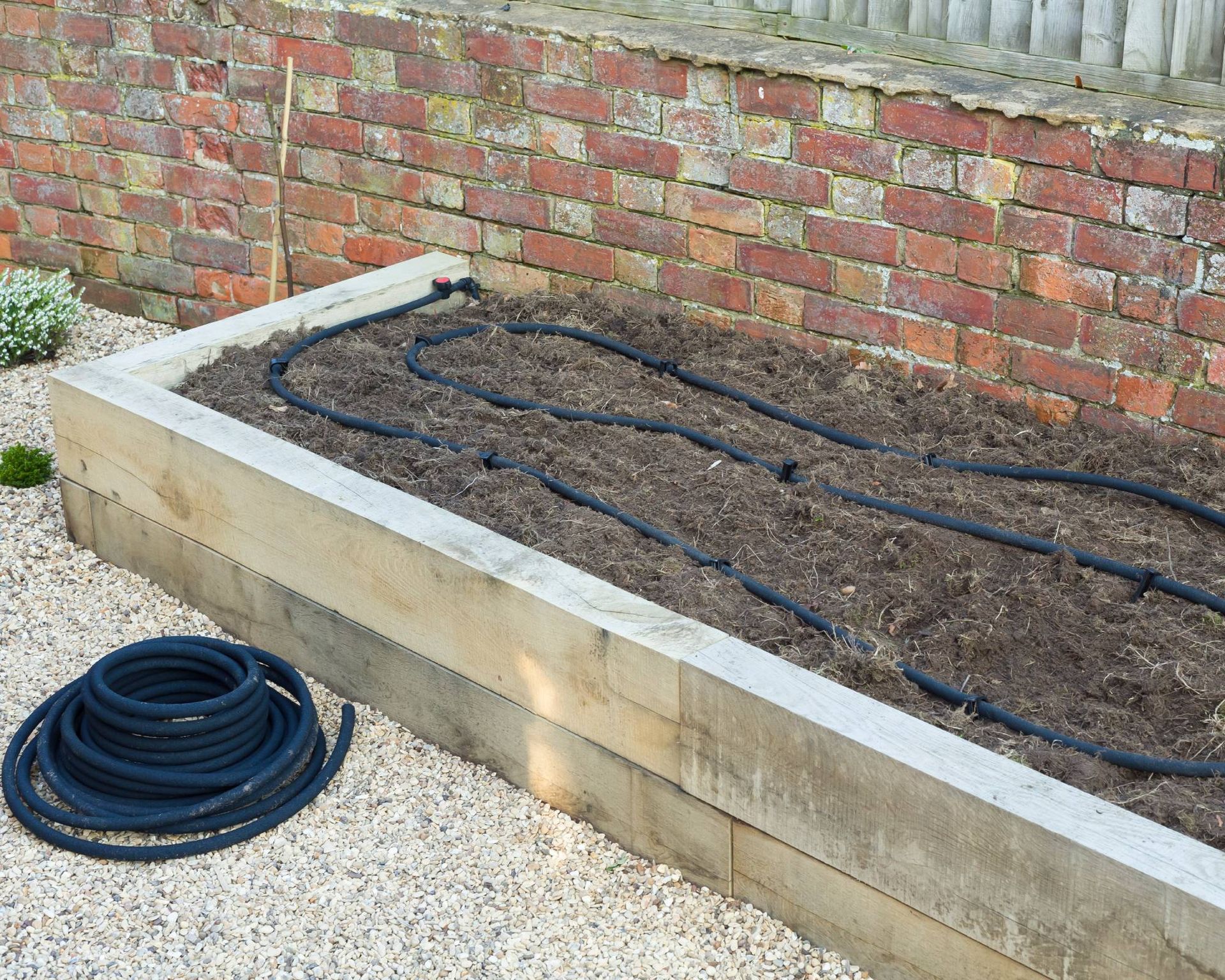 Soaker hose installed in raised bed